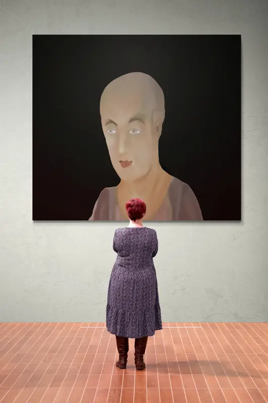 woman standing in front of gallery wall